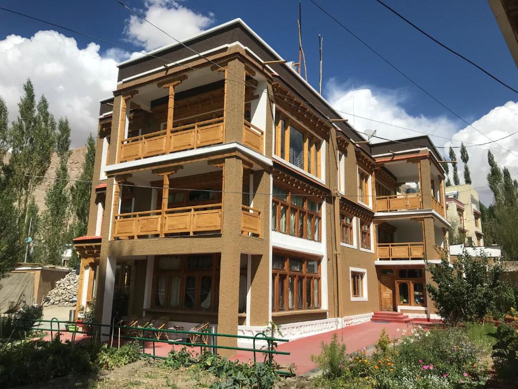 a building with wooden balconies on the side of it at Sangto Green Guest House in Leh