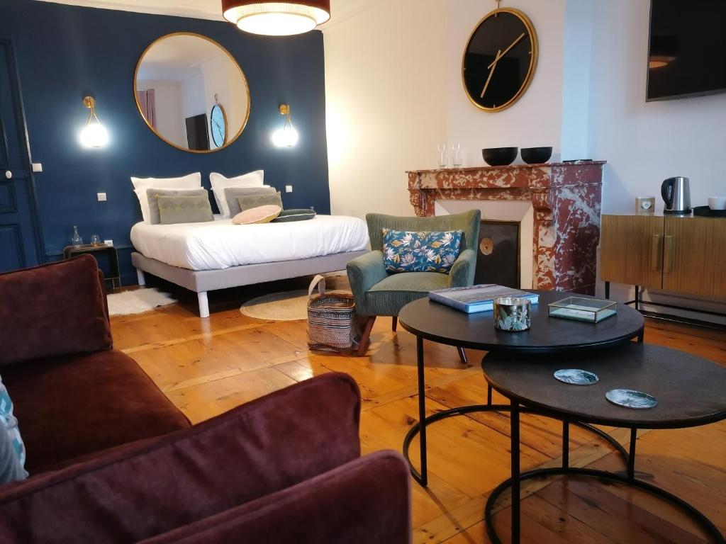 a living room with a bed and a fireplace at Le 43-3 avec sauna privatif in Le Puy en Velay