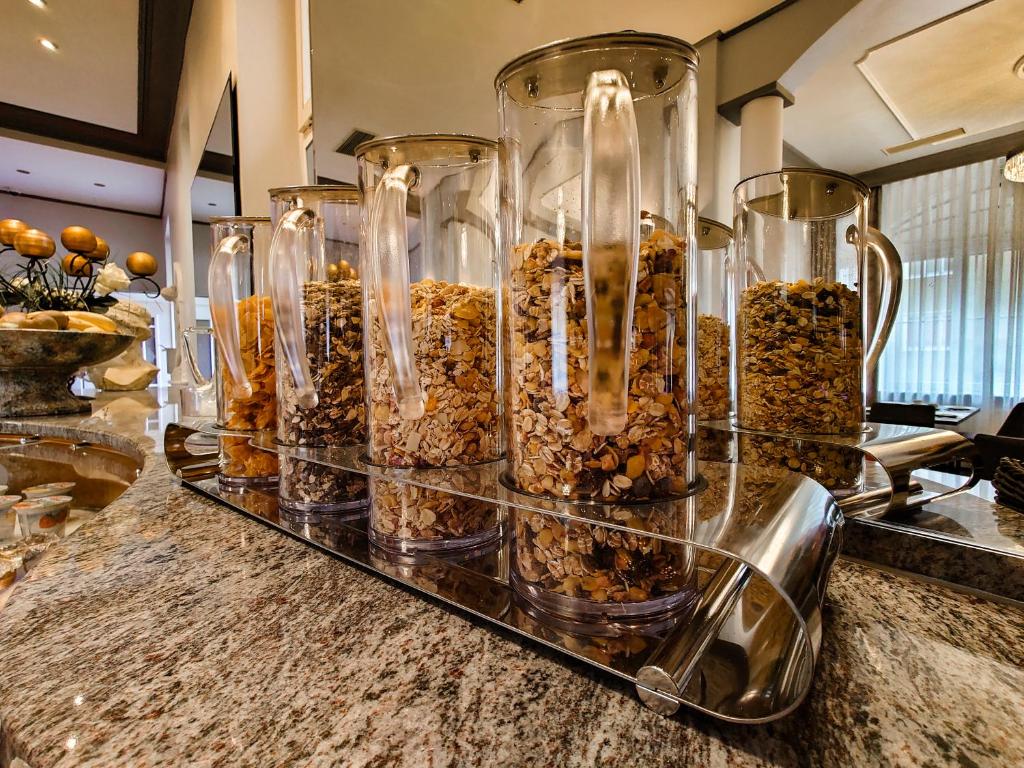 a group of glass containers filled with different types of nuts at Work & Travel - KRAL Hotels Erlangen in Erlangen