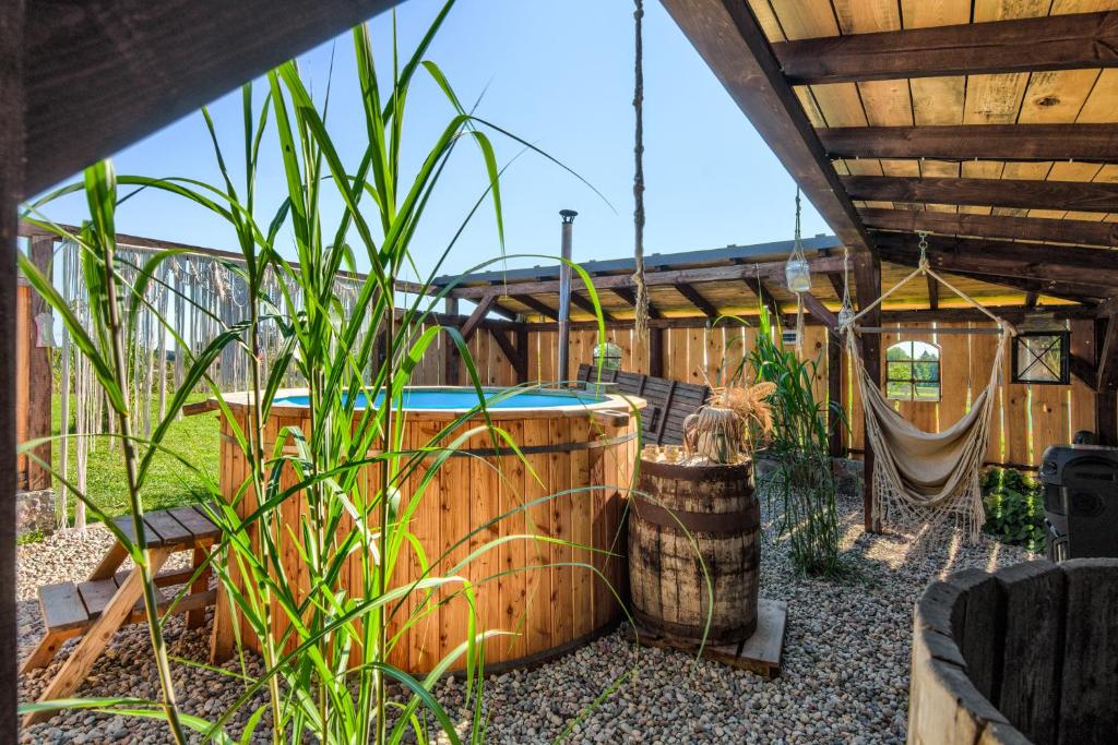 a backyard with a swimming pool and a hammock at pod mazurskim niebem loft in Piecki