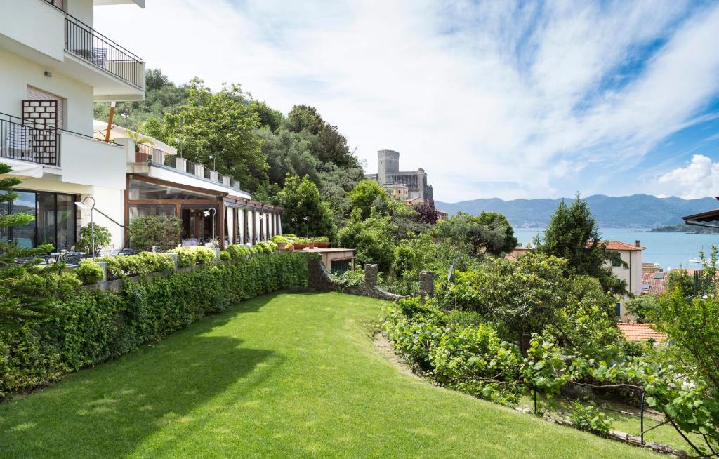 a view of a house with a green yard at Doria Park Hotel in Lerici
