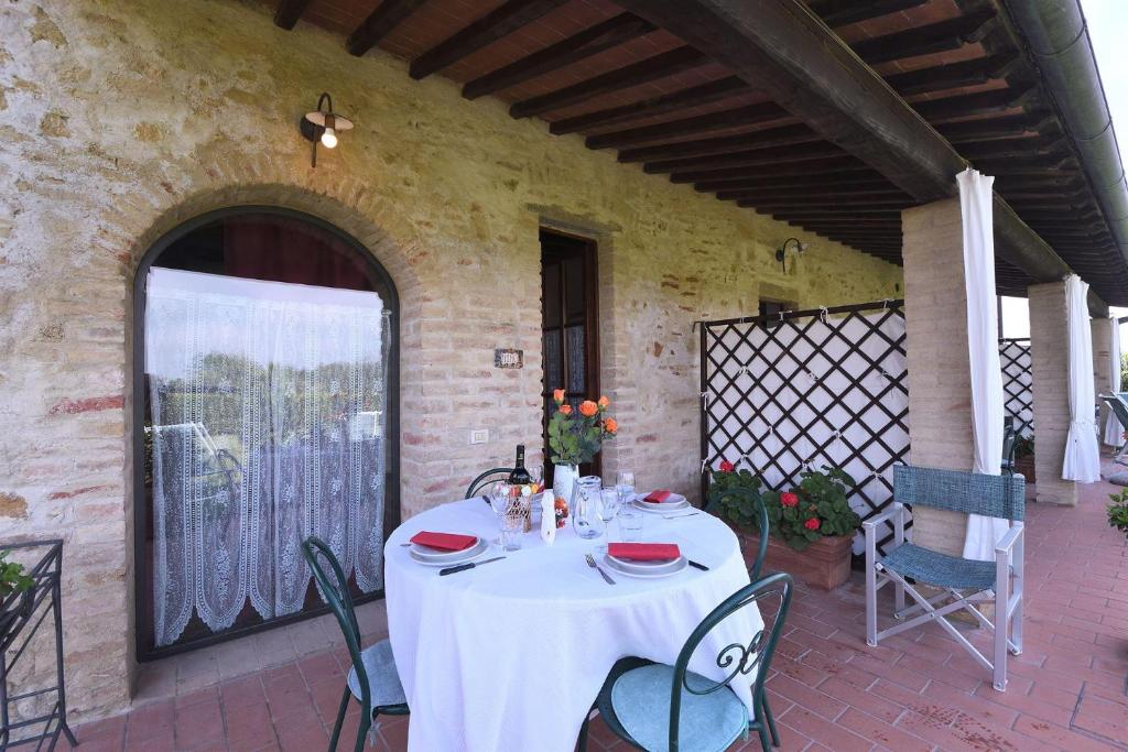a table with a white table cloth on a patio at Fieno in SantʼAppiano
