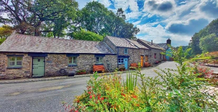 a row of stone cottages on the side of a road at Maes Madog Cottages in Betws-y-coed