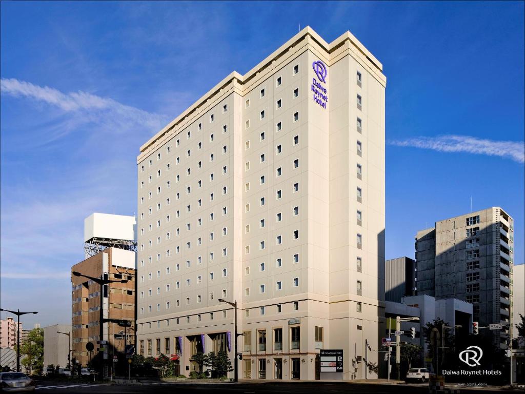 a large white building with a sign on it at Daiwa Roynet Hotel Sapporo-Susukino in Sapporo