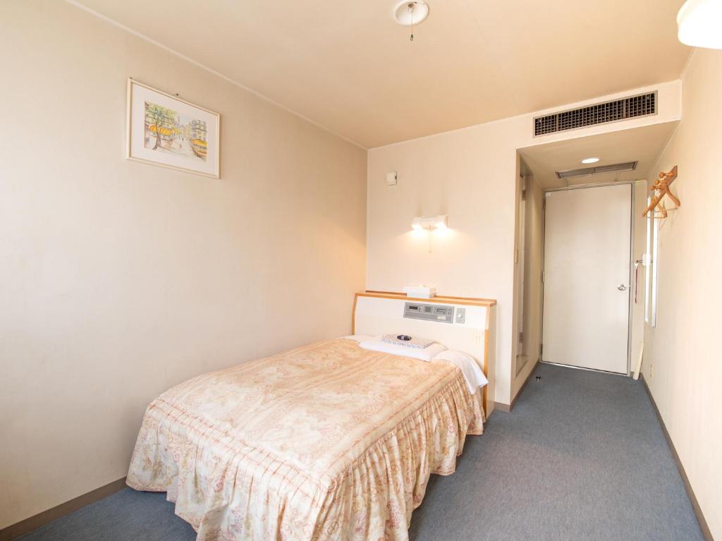 Postel nebo postele na pokoji v ubytování Tabist Hotel Sun Plaza Fuefuki Isawa