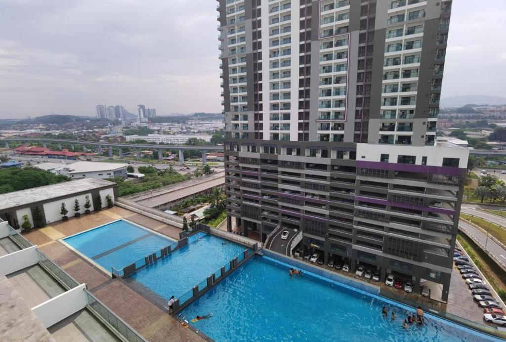 an aerial view of a building with two swimming pools at Landmark Residence 2 Service Apartment 5min to MRT 20min to KL in Kajang
