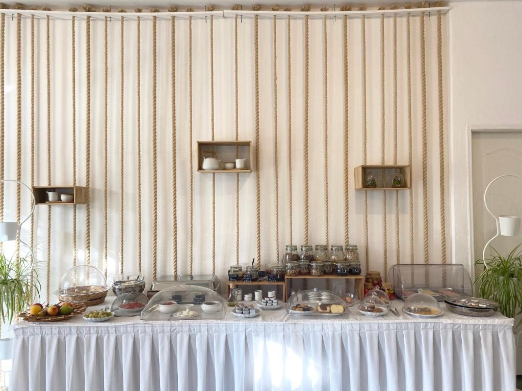 a table with plates of food on top of it at Asteri Hotel in Livadi