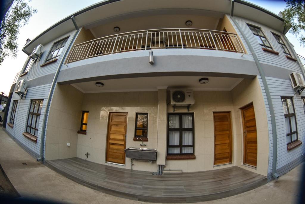 een rond huis met een ronde veranda en een balkon bij Apartment Two-One-Two Eleven in Gaborone