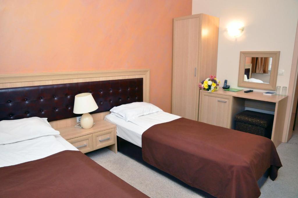 Postel nebo postele na pokoji v ubytování Olymp Hotel