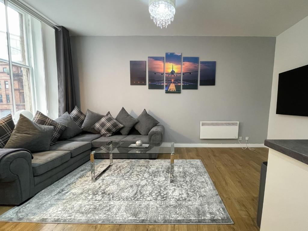 a living room with a couch and a table at Exquisite 2BR Flat near Central Train Station in Glasgow