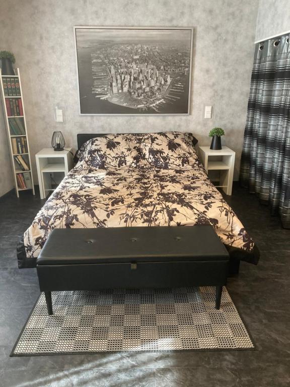 a bedroom with a bed with a table in it at Klein aber fein-Modernes Apartment mitten in der Stadt und doch sehr ruhig- WLAN kostenlos in Bad Ems