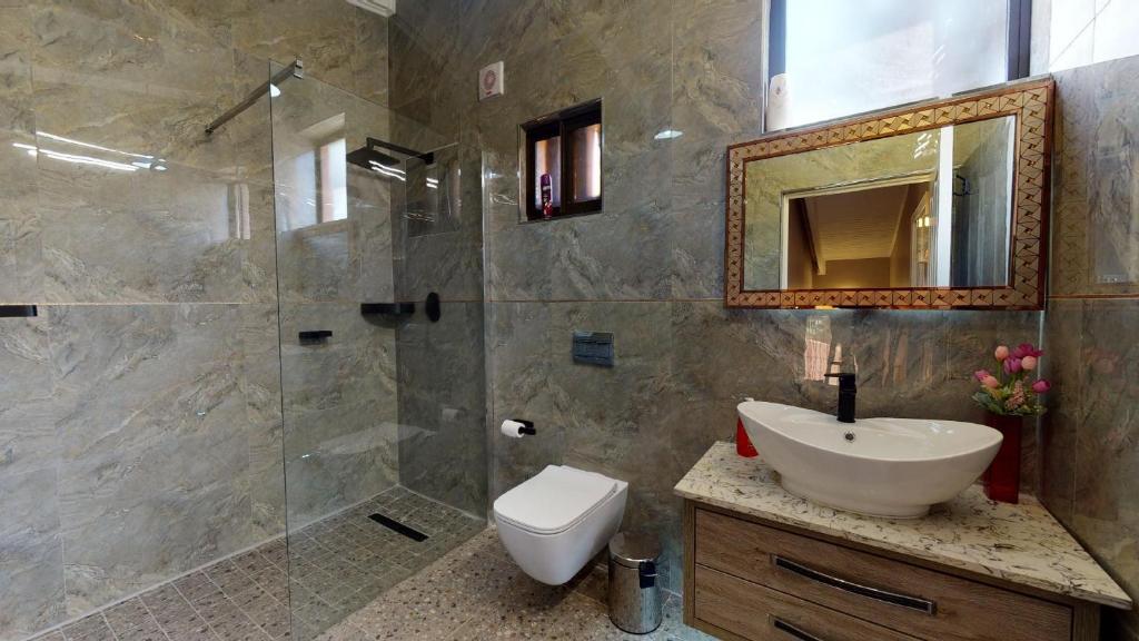 a bathroom with a shower and a sink and a mirror at San Lameer Villa 2910 by Top Destinations Rentals in Southbroom