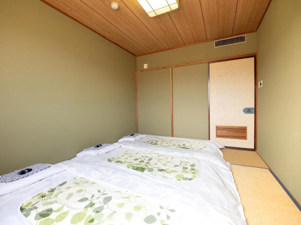 Postel nebo postele na pokoji v ubytování Tabist Hotel Sun Plaza Fuefuki Isawa