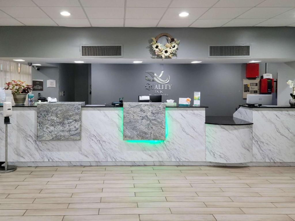 a lobby with a large marble counter in a building at Quality Inn Terre Haute University Area in Terre Haute