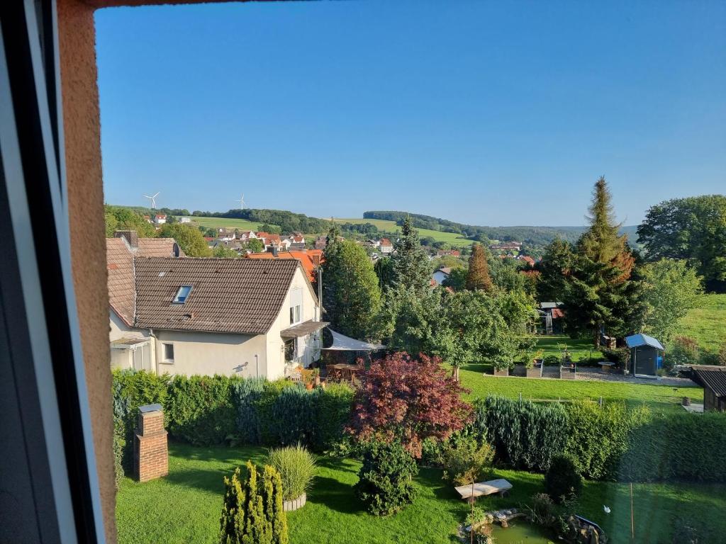a view of a garden from a window at Ferienwohnung Söhreblick in Wattenbach