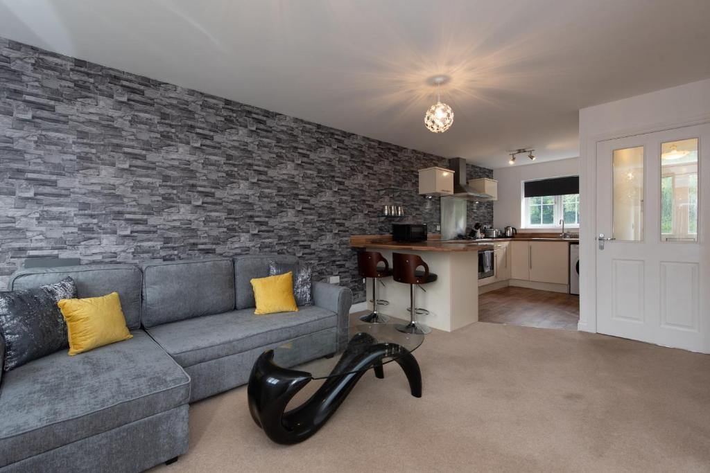 a living room with a couch and a brick wall at Park View in Billingham