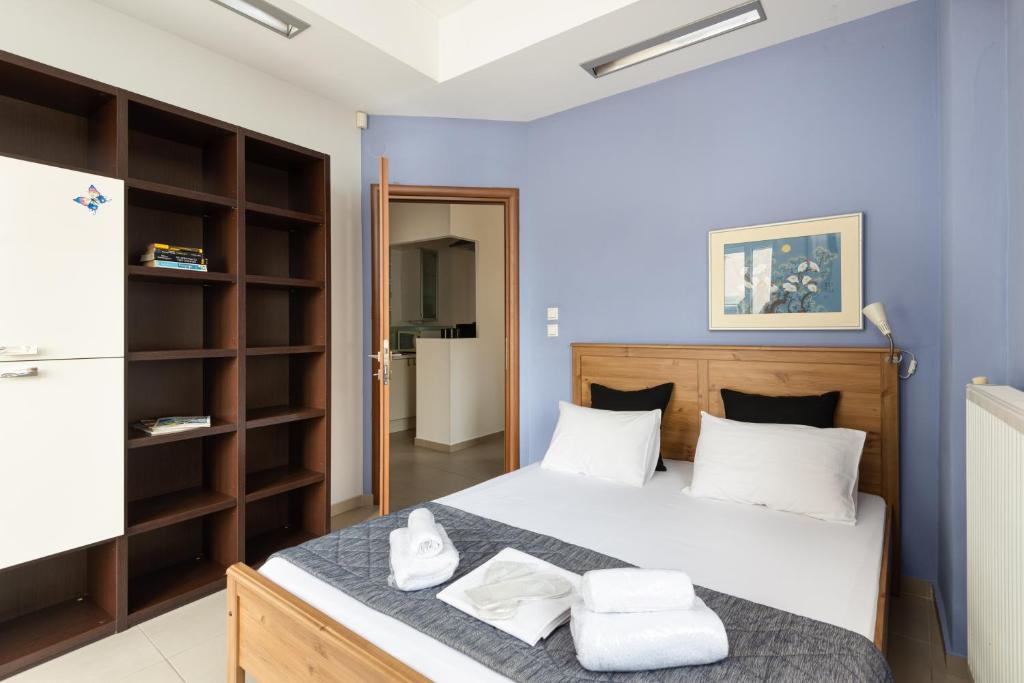 a bedroom with a bed with towels on it at Delmare Dahlia double apartment in Thessaloniki