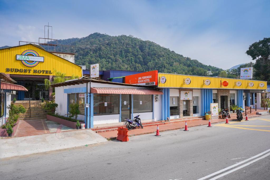 a row of shops on the side of a street at JMA FERRINGHI BEACH HOTEL in Batu Ferringhi