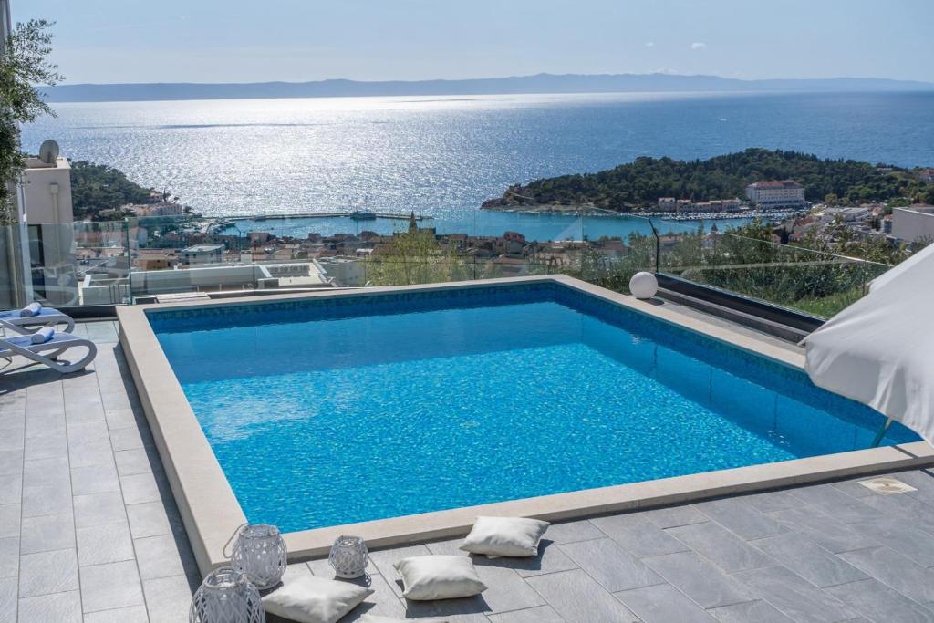 a swimming pool with a view of the ocean at NEW! Villa Lea 5-bedroom villa with private pool and amazing views of city and sea in Makarska