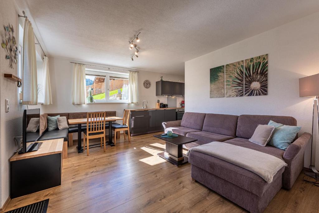 a living room with a couch and a table at Ferienwohnung Alpenglück in Sankt Jakob in Haus