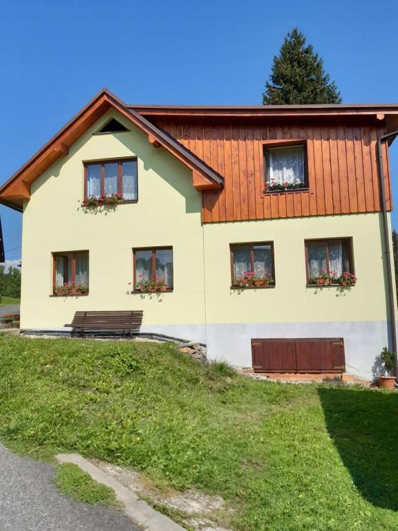 a house with a wooden roof at Privat Pohoda in Paseky nad Jizerou