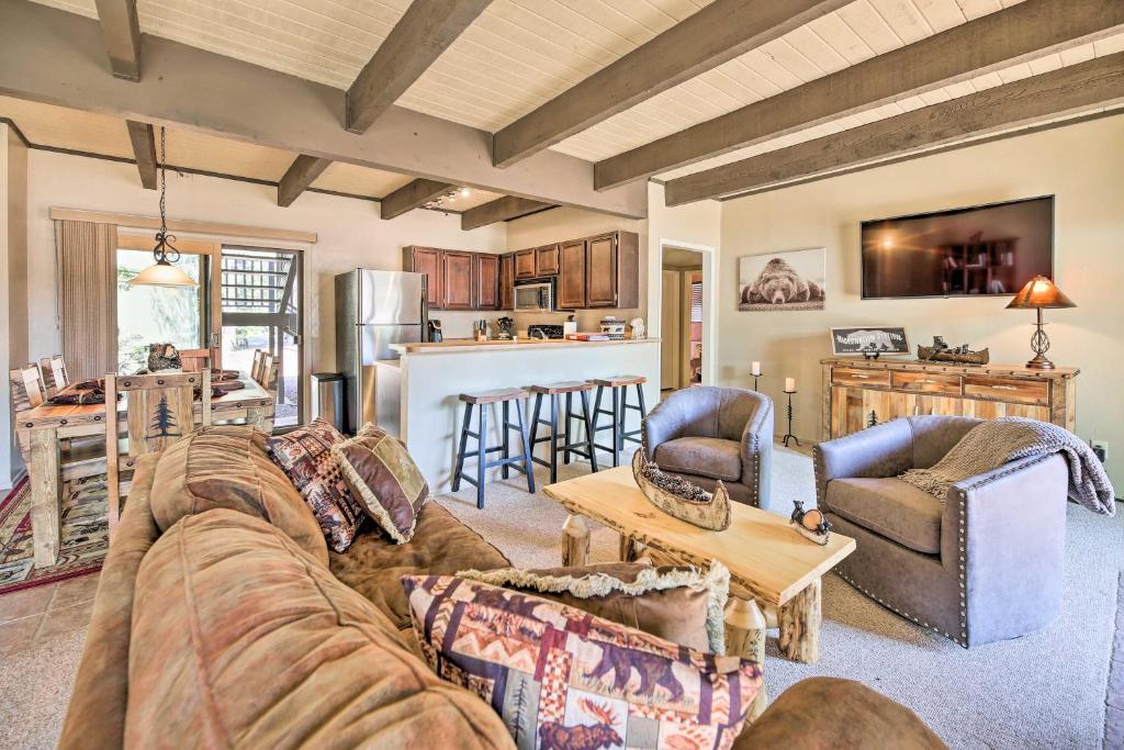 a living room with a couch and a table at Patio and Fireplace Country Club Pinetop Condo! in Indian Pine