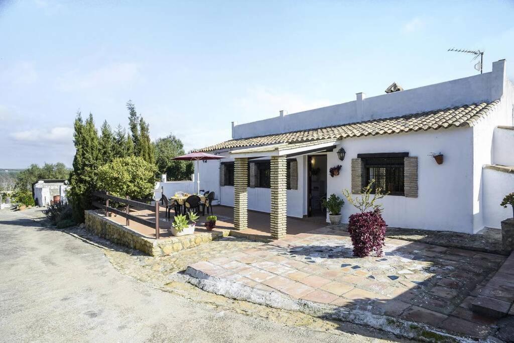 een wit huis met een binnenplaats ervoor bij casa rural Santamaría con piscina y wifi in Vejer de la Frontera