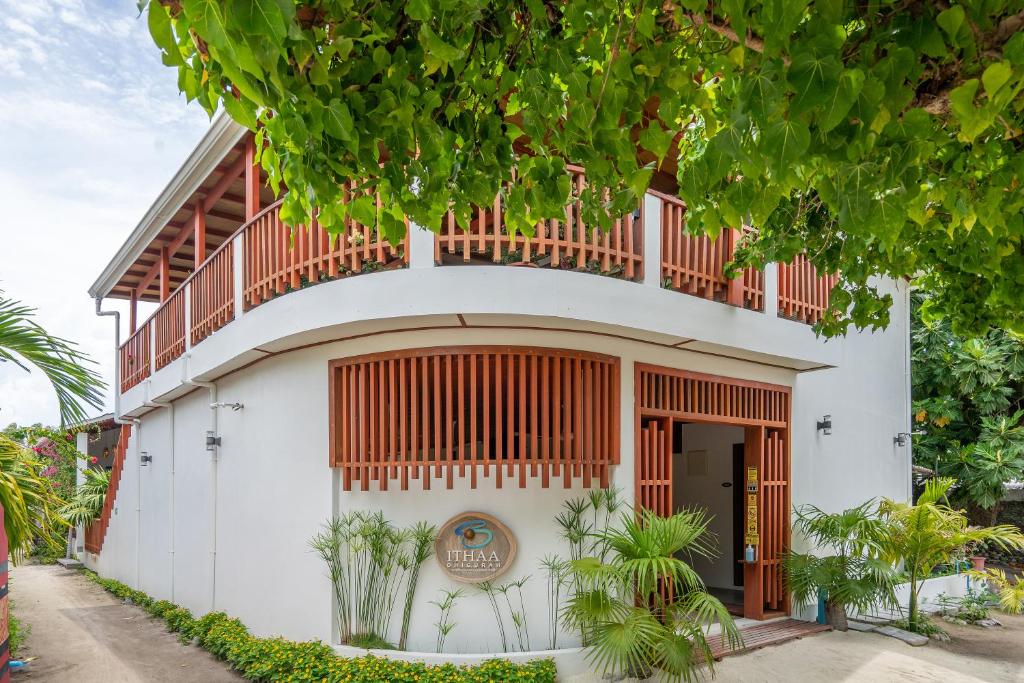 a building with a balcony on top of it at Ithaa Dhigurah in Dhigurah