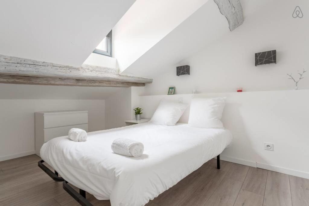a bedroom with a large white bed with white pillows at T3 La Tronche Near hospital #A5 in La Tronche