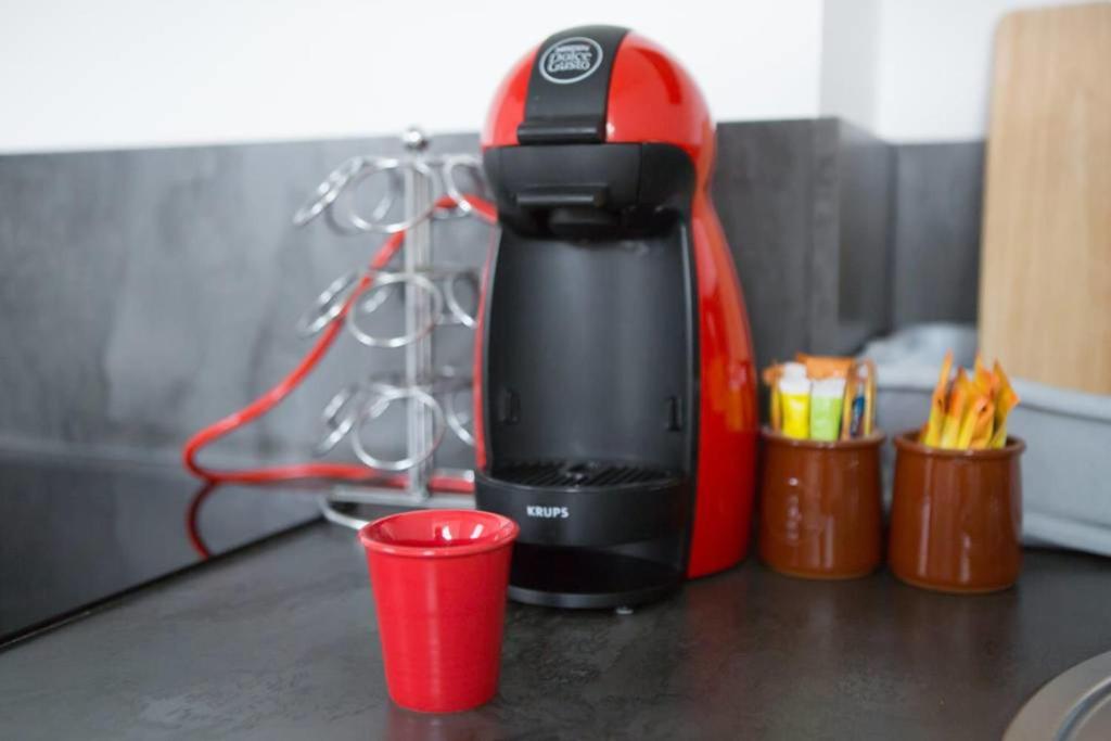 a coffee maker and a red cup on a counter at T3 La Tronche Near hospital #A5 in La Tronche