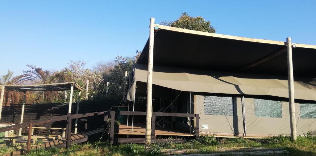 a tent that is sitting in the grass at Chosen Glamping Tents in Graskop