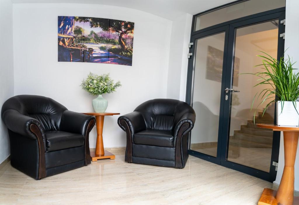 two black leather chairs sitting in a room at Ubytovanie SASINKOVA in Žilina