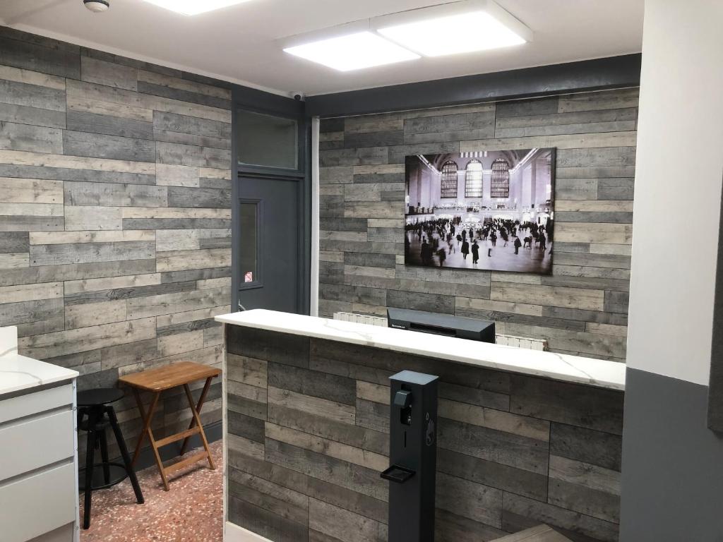 a bar in a room with a brick wall at Barking Park Hotel in Barking