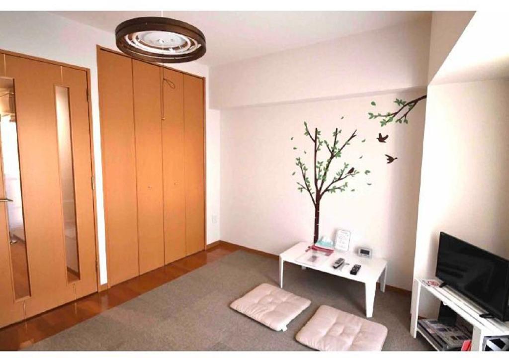 a room with a table and a tree on the wall at Marvelous Kokubunji - Vacation STAY 41073v in Kokubunji