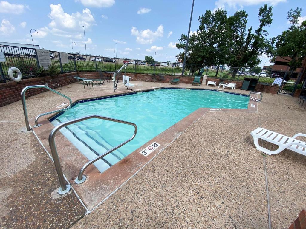 a small swimming pool with a metal railing around it at Motel 6 Oklahoma City OK Fairgrounds West in Oklahoma City