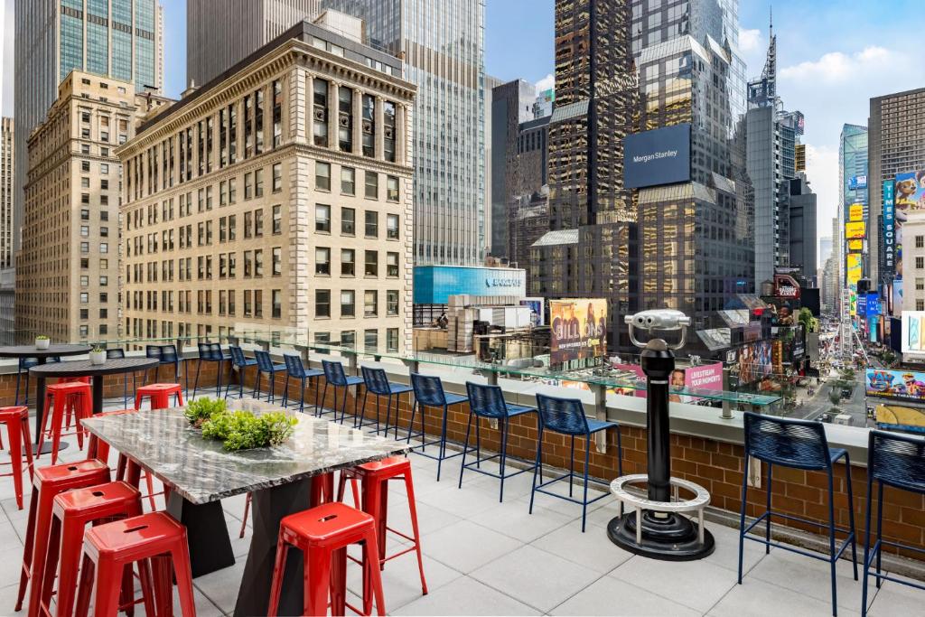 a table and chairs on the roof of a building at M Social Hotel Times Square New York in New York