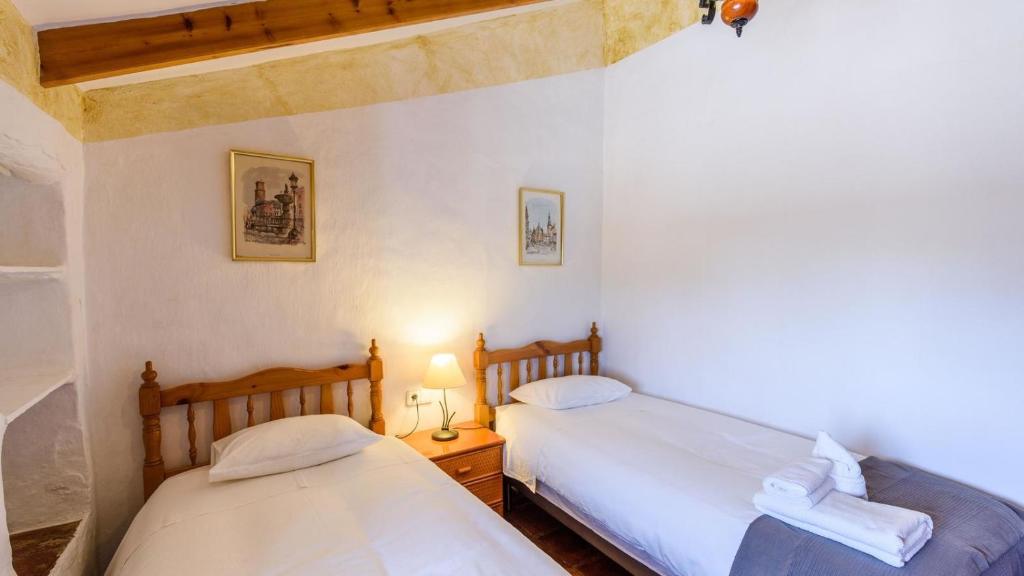 A bed or beds in a room at Finca Tarabita Competa by Ruralidays