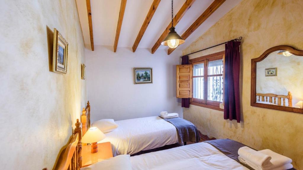 A bed or beds in a room at Finca Tarabita Competa by Ruralidays