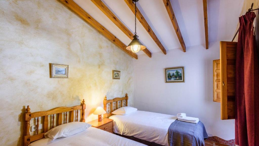 A bed or beds in a room at Finca Tarabita Competa by Ruralidays