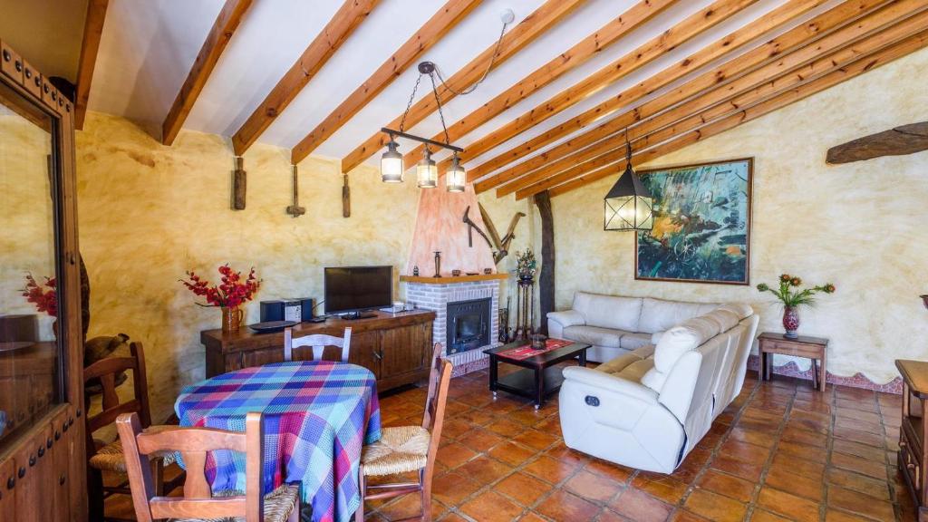 A television and/or entertainment centre at Finca Tarabita Competa by Ruralidays
