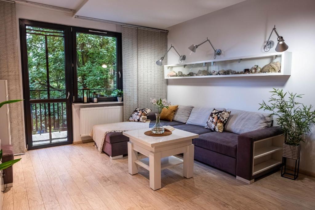 a living room with a couch and a table at Smart Executive in Kraków