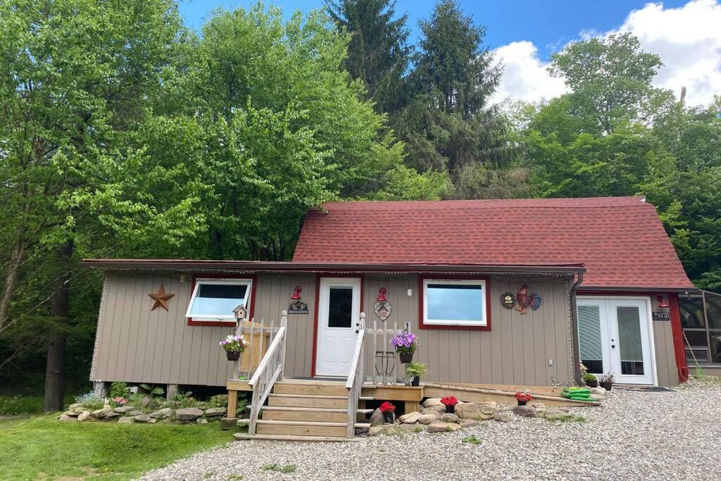 a small tiny house with a red roof at Roscoe Cottage Pet Friendly in Roscoe