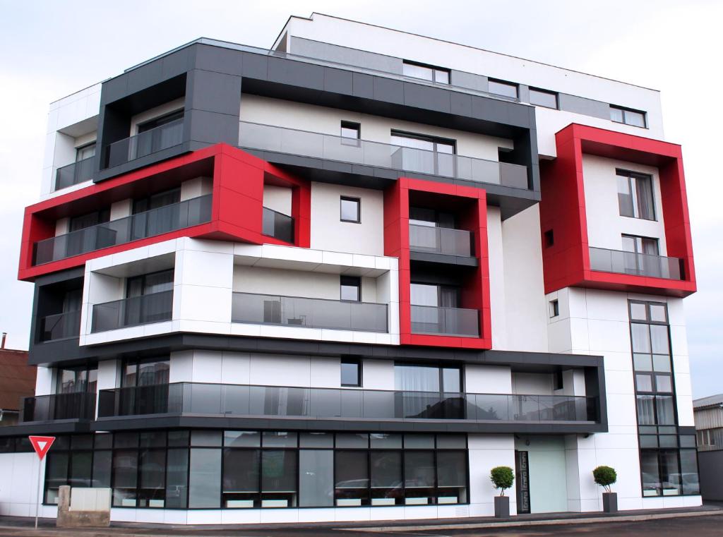 a red and white apartment building at Hotel Tempo in Târgu-Mureş