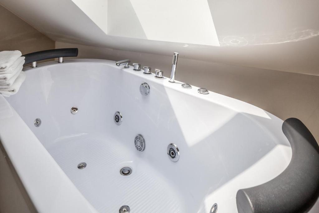 a white bath tub sitting in a room at GL Suites in Wiesbaden