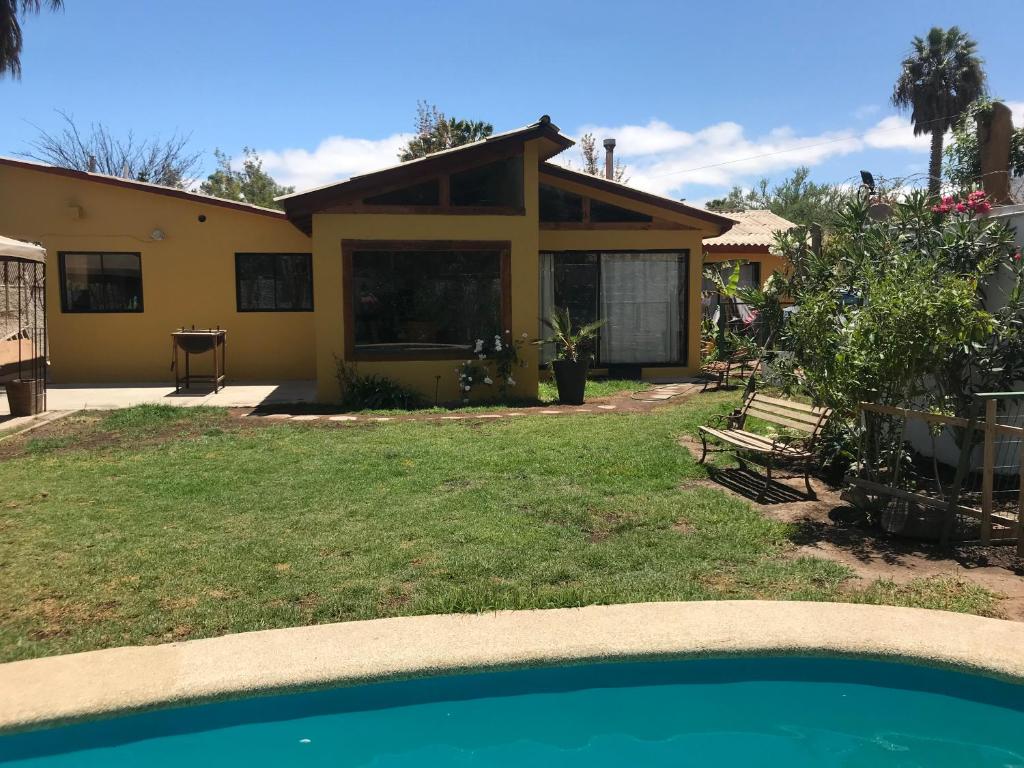 a house with a swimming pool in front of it at Gran Casa a pasos Casino ANTAY in Copiapó