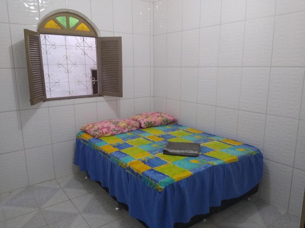a room with a bed with a laptop on it at Quarto casal sossegado perto Pelourinho in Salvador