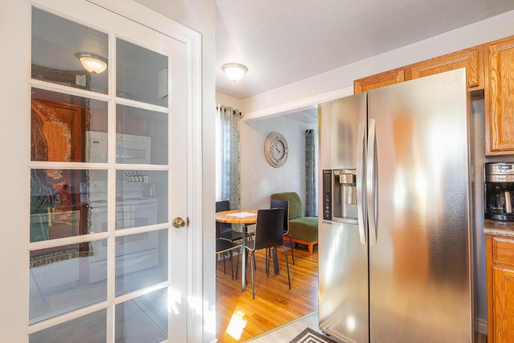 a kitchen with a stainless steel refrigerator and a table at Duplex in Alberta Art District in Portland