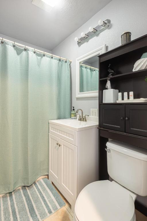 a bathroom with a toilet and a sink and a shower at Duplex in Alberta Art District in Portland
