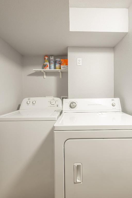 a white laundry room with a washer and dryer at Duplex in Alberta Art District in Portland