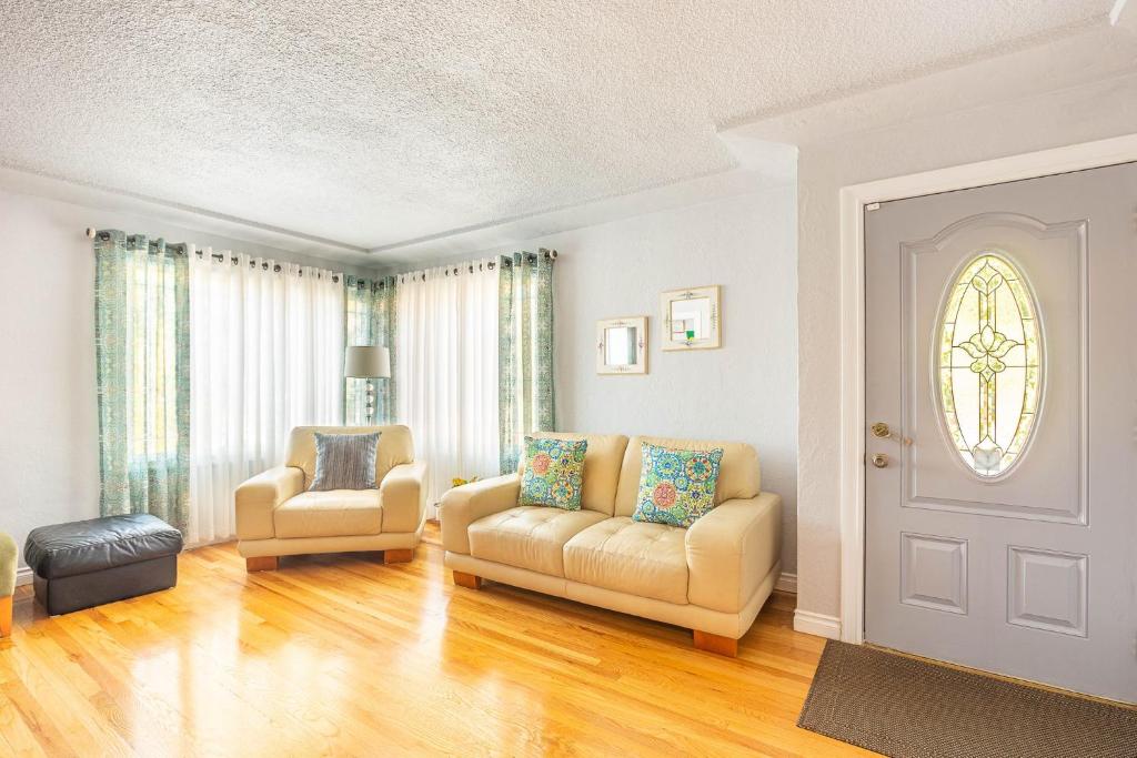 a living room with a couch and a chair at Duplex in Alberta Art District in Portland